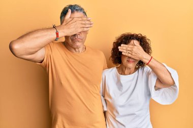 Güzel, orta yaşlı bir çift birlikte sıradan kıyafetler giyiyorlar. Gözleri kapatıyorlar, ciddi ve üzgün görünüyorlar. Görme, saklama ve reddetme konsepti 