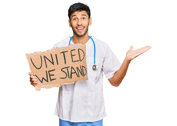 Young Handsome Man Wearing Doctor Uniform Holding United Stand Banner — Stock Photo, Image