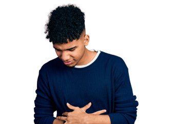 Afro-Amerikalı genç bir adam, hazımsızlık, acı verici bir hastalık ve midesi üzerine gündelik giysiler giyiyor. Ağrı kavramı. 