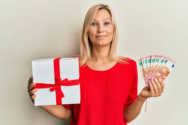 Middle Age Caucasian Woman Holding Gift Euros Banknotes Relaxed Serious — Stock Photo, Image