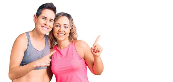 Couple Women Wearing Sportswear Smiling Looking Camera Pointing Two Hands — Stock Photo, Image