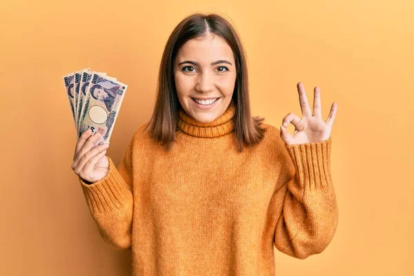 Elinde 5000 Japon Doları Tutan Genç Bir Kadın Parmaklarıyla Imza — Stok fotoğraf