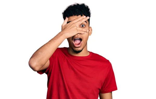 Young African American Man Wearing Casual Red Shirt Peeking Shock — Stock Photo, Image