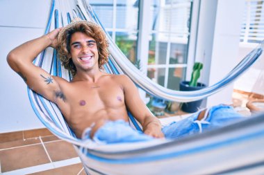 Genç İspanyol adam rahatlamış gülümsüyor mutlu bir şekilde terasta yatıyordu..