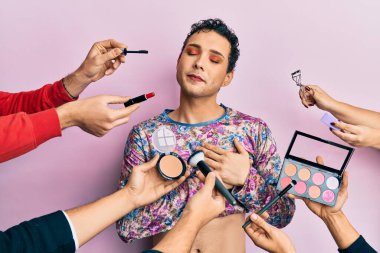 Makyaj malzemeleriyle makyaj yapan yakışıklı bir adam. Elleri göğsünde gülümseyen, gözleri kapalı, yüzünde minnet ifadesi olan bir adam. sağlık kavramı. 