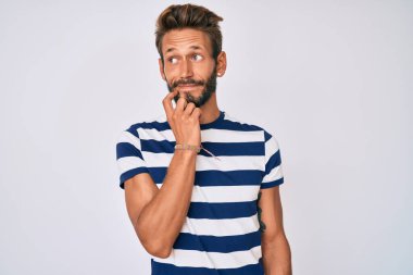 Sakallı, sıradan çizgili tişört giyen, yakışıklı beyaz bir adam ciddi bir yüz ifadesi olan, eli çenesinde soru soran, kafa karıştırıcı bir fikir hakkında düşünceli biri. 