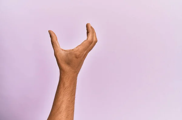 Arm Hand Caucasian Young Man Pink Isolated Background Picking Taking — Stock Photo, Image