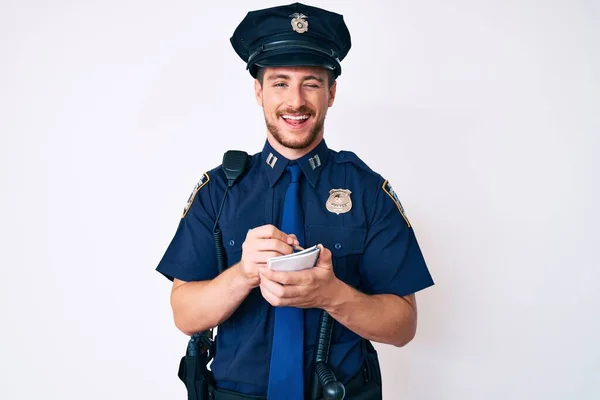 Young Caucasian Man Wearing Police Uniform Writing Fine Winking Looking — Stock Photo, Image
