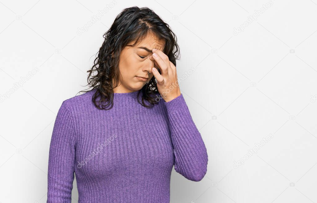 Young hispanic woman wearing casual clothes tired rubbing nose and eyes feeling fatigue and headache. stress and frustration concept. 