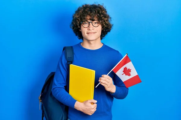 英俊的年轻人交换着拿着加拿大国旗的学生 脸上挂着快乐而沉着的微笑 显示牙齿 — 图库照片