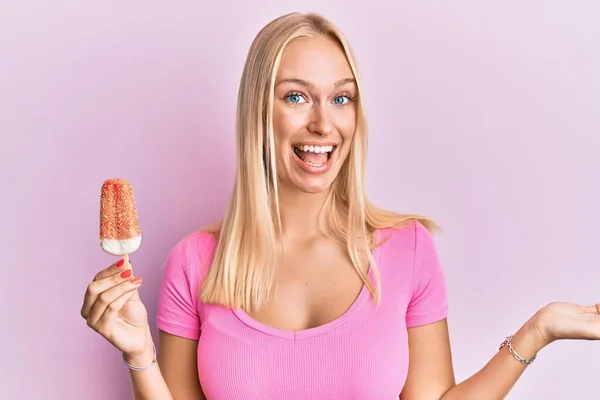 Young Blonde Girl Holding Ice Cream Celebrating Achievement Happy Smile — Stock Photo, Image