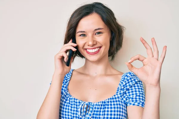 Young Beautiful Girl Having Conversation Talking Smartphone Doing Sign Fingers — Stock Photo, Image