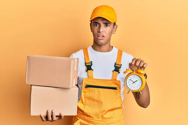 Young Handsome African American Man Holding Delivery Box Alarm Clock — Foto de Stock