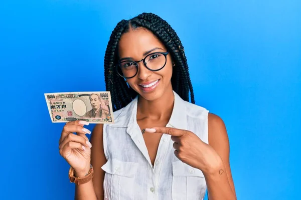 Hermosa Mujer Hispana Sosteniendo Billetes Yen Japoneses Sonriendo Feliz Señalando —  Fotos de Stock