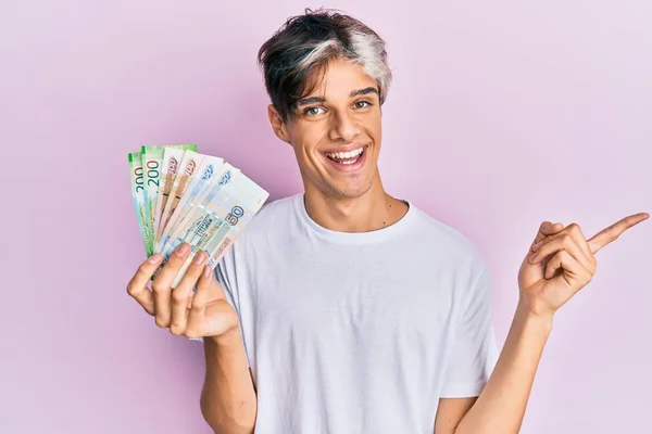 Joven Hispano Sosteniendo Billetes Rublo Rusos Sonriendo Feliz Señalando Con —  Fotos de Stock