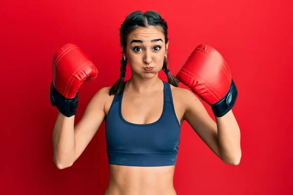 Young Brunette Girl Using Boxing Gloves Wearing Braids Puffing Cheeks — Stock Photo, Image