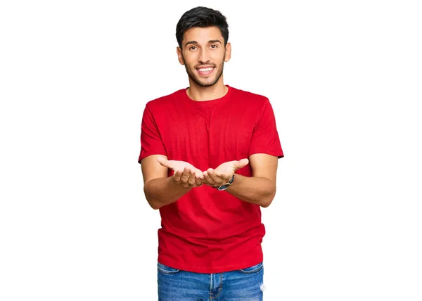 Elleri Avuçlarında Gülümseyen Sıradan Kırmızı Tişörtler Giyen Genç Yakışıklı Adam — Stok fotoğraf