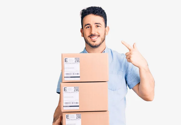 Young Hispanic Man Holding Delivery Package Pointing Finger One Self — Stock Photo, Image