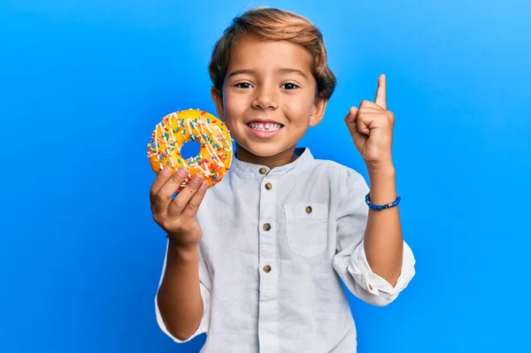 Adorable Niño Latino Sosteniendo Donut Sonriendo Con Una Idea Pregunta — Foto de Stock