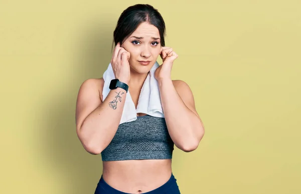 Young Hispanic Girl Wearing Sportswear Towel Covering Ears Fingers Annoyed — Stock Photo, Image