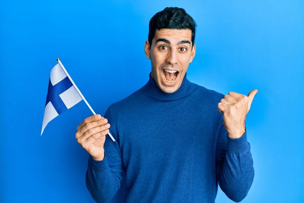 Finlandiya Bayrağını Tutan Yakışıklı Ağzı Açık Gülümseyen Gülümseyen Bir Spanyol — Stok fotoğraf
