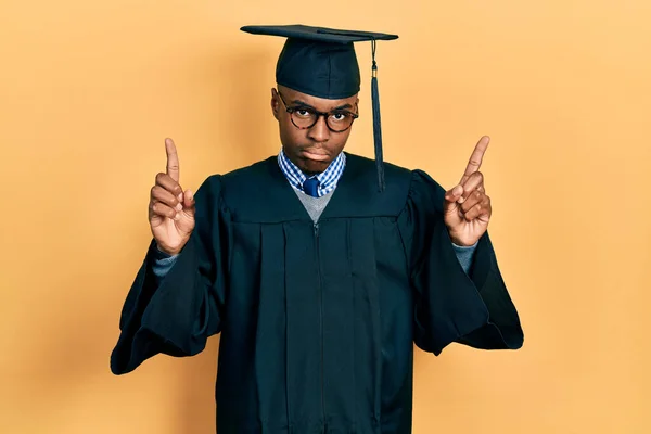 Young African American Man Wearing Graduation Cap Ceremony Robe Pointing — Stock Photo, Image