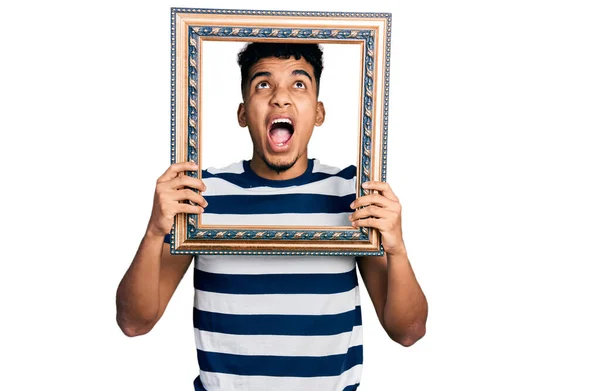 Young African American Man Holding Empty Frame Angry Mad Screaming — Stok fotoğraf