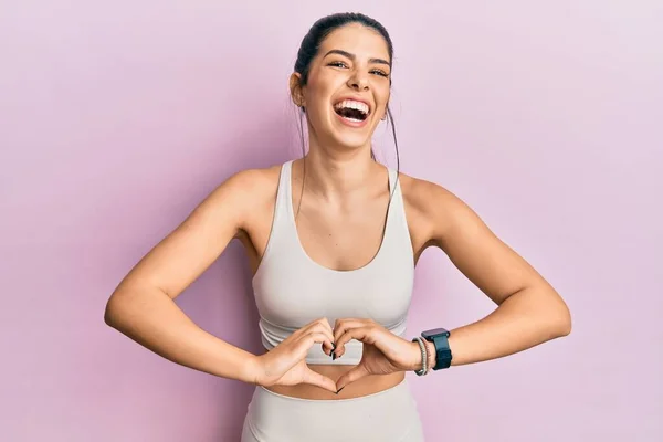 Young Hispanic Woman Wearing Sportswear Doing Heart Symbol Hands Smiling — Stok fotoğraf