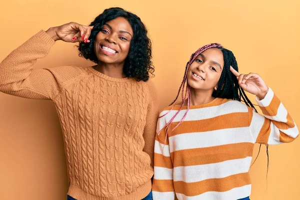 美しいアフリカ系アメリカ人の母親と娘は 1本の指で頭を指して笑顔ウールの冬のセーターを着て 素晴らしいアイデアや考え 良い思い出 — ストック写真