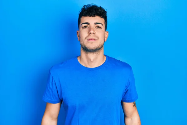 Young Hispanic Man Wearing Casual Blue Shirt Relaxed Serious Expression — ストック写真