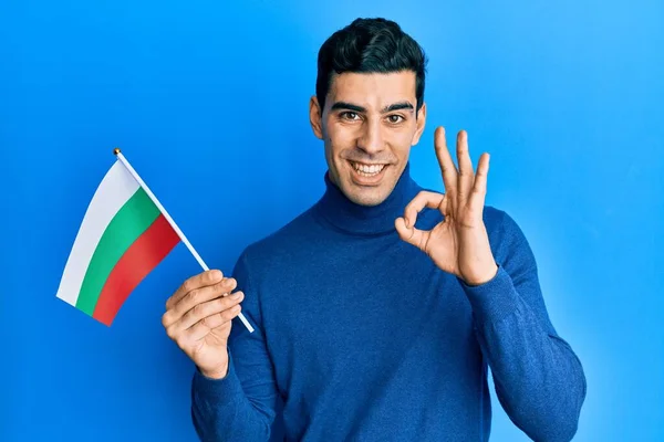 Handsome Hispanic Man Holding Bulgarian Flag Doing Sign Fingers Smiling — Stock Photo, Image