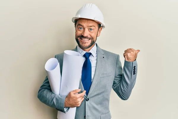 Middle Age Architect Man Wearing Safety Helmet Holding Blueprints Pointing — ストック写真
