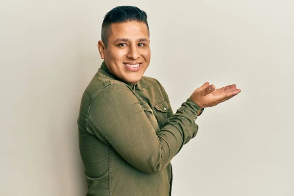 Young Latin Man Wearing Casual Clothes Pointing Aside Hands Open — Stock Photo, Image