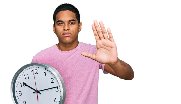 Young Handsome Hispanic Man Holding Big Clock Open Hand Doing — Stock Photo, Image