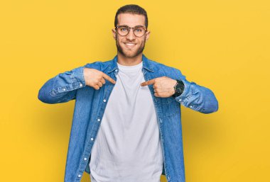 Young caucasian man wearing casual clothes looking confident with smile on face, pointing oneself with fingers proud and happy.  clipart