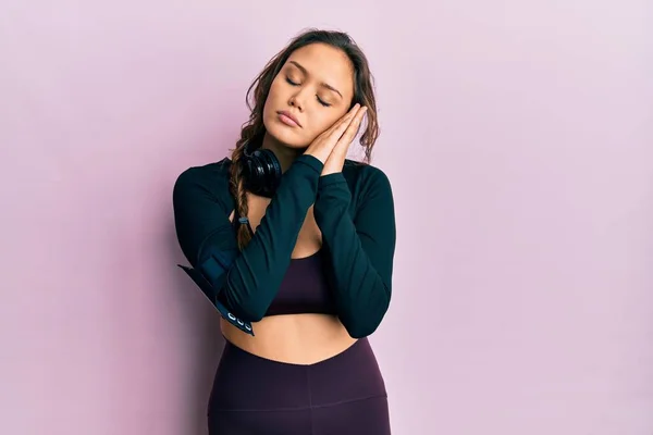 Young Hispanic Girl Wearing Sportswear Headphones Sleeping Tired Dreaming Posing — Φωτογραφία Αρχείου