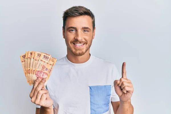 Handsome Caucasian Man Holding Mexican Pesos Smiling Idea Question Pointing —  Fotos de Stock