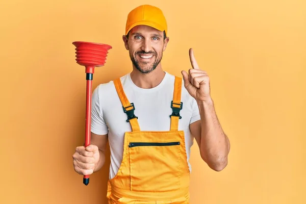 Young Handsome Man Wearing Plumber Uniform Holding Toilet Plunger Smiling — Stockfoto