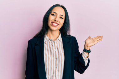 İş elbiseleri giyen, neşeli gülümseyen, avuç içi kameraya bakan genç İspanyol kız.. 