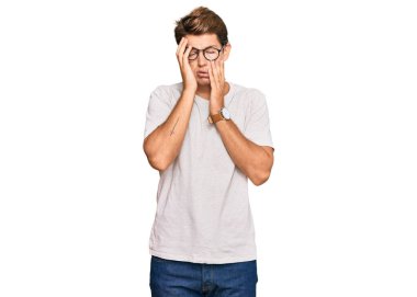 Handsome caucasian man wearing casual clothes and glasses tired hands covering face, depression and sadness, upset and irritated for problem 