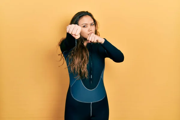 Young Hispanic Girl Wearing Diver Neoprene Uniform Punching Fist Fight — Stockfoto