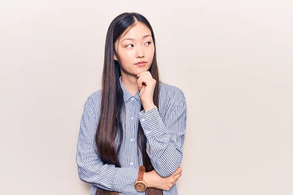 Young Beautiful Chinese Woman Wearing Casual Striped Shirt Thinking Concentrated — Stock Photo, Image