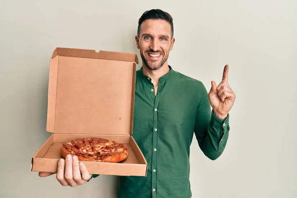 Handsome Man Beard Holding Italian Pizza Smiling Happy Pointing Hand — Stock Fotó