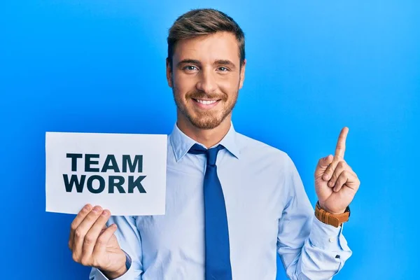 Handsome Caucasian Business Man Holding Team Work Banner Smiling Happy — Stock Photo, Image