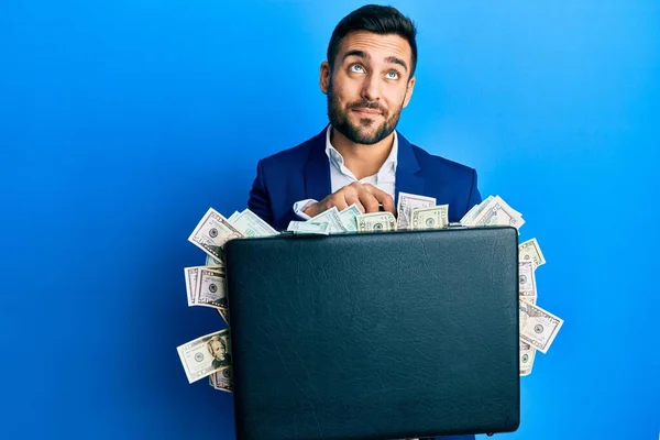 Young Hispanic Businessman Holding Briefcase Full Dollars Smiling Looking Side — ストック写真