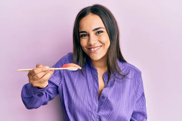 Giovane Donna Bruna Che Mangia Sushi Usando Bacchette Che Sembrano — Foto Stock