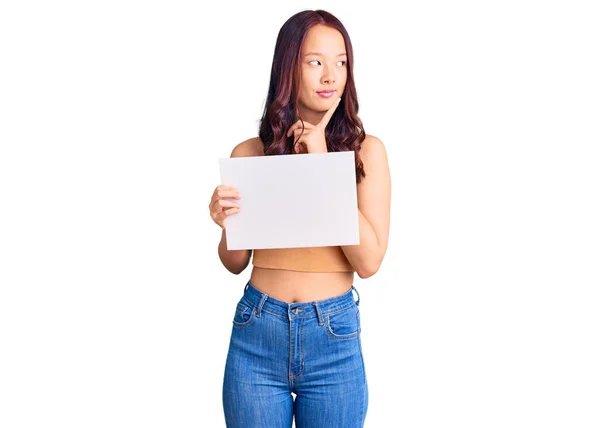 Young Beautiful Chinese Girl Holding Paper Banner Blank Space Serious — Stock Photo, Image