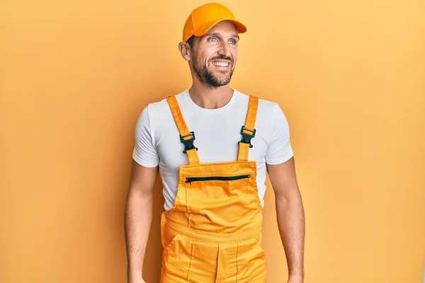 Young Handsome Man Wearing Handyman Uniform Yellow Background Looking Away — Stockfoto