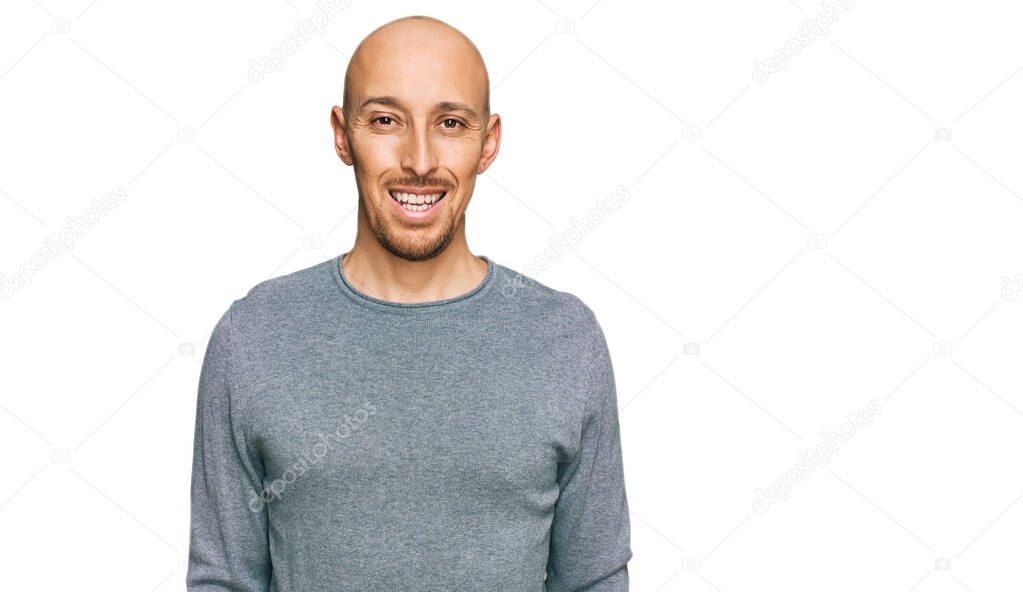 Bald man with beard wearing casual clothes with a happy and cool smile on face. lucky person. 