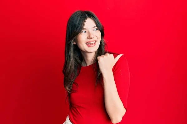 Young Beautiful Caucasian Girl Wearing Casual Red Shirt Pointing Thumb — Φωτογραφία Αρχείου